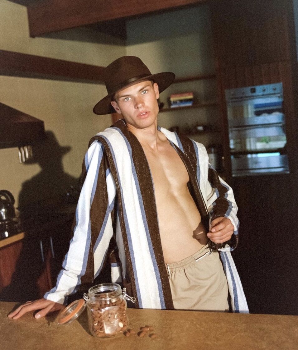 man wearing the best fedora for men in a bathrobe