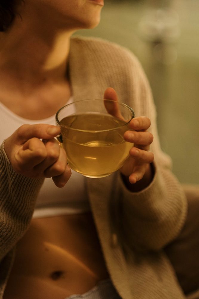 woman drinking green tea to balance her hormones