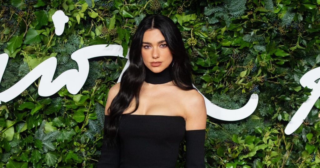 Dua Lipa Paired a Pinstripe Minidress With Thigh-High Boots Dua Lipa Paired a Pinstripe Minidress With Thigh-High Boots